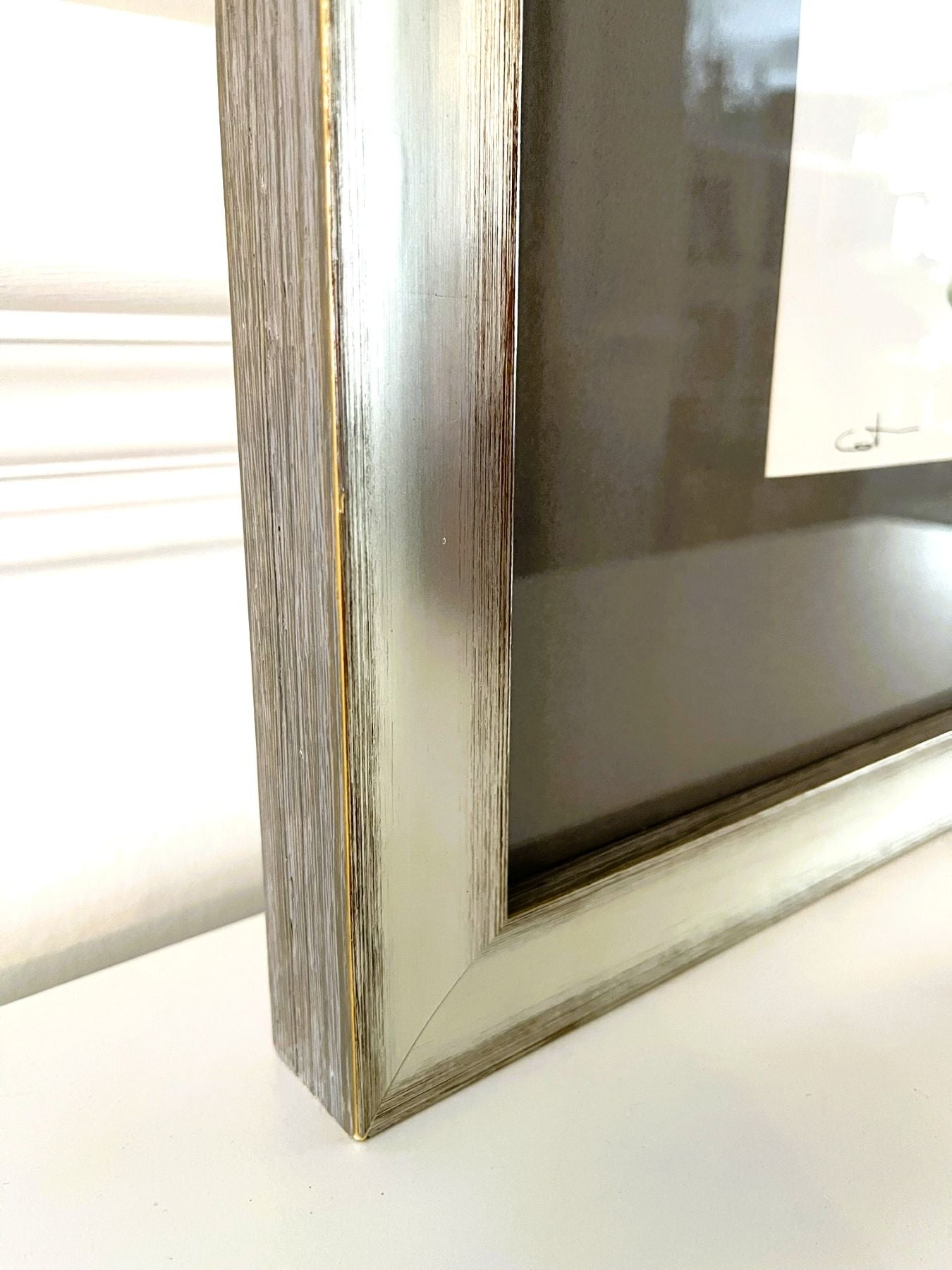 Close-up of a wooden picture frame on a white surface