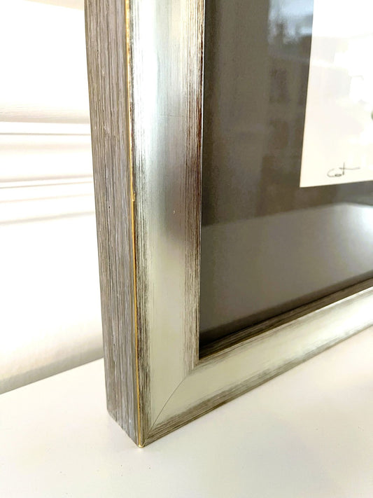 Close-up of a wooden picture frame on a white surface