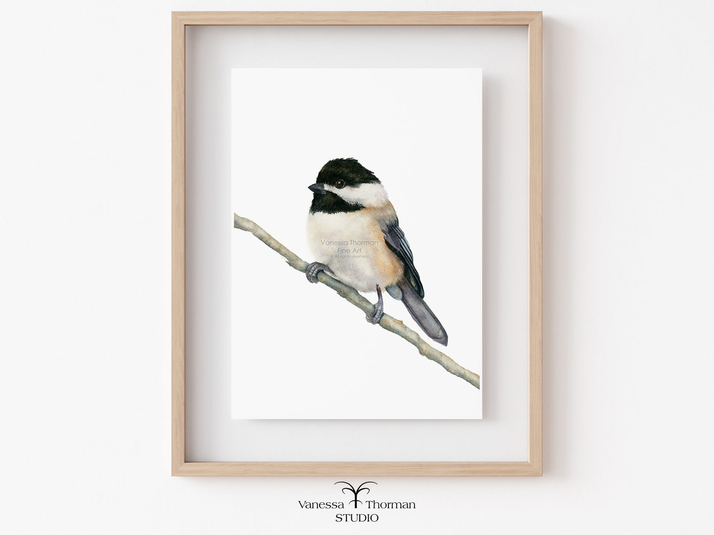 Framed artwork of a chickadee bird on a branch 