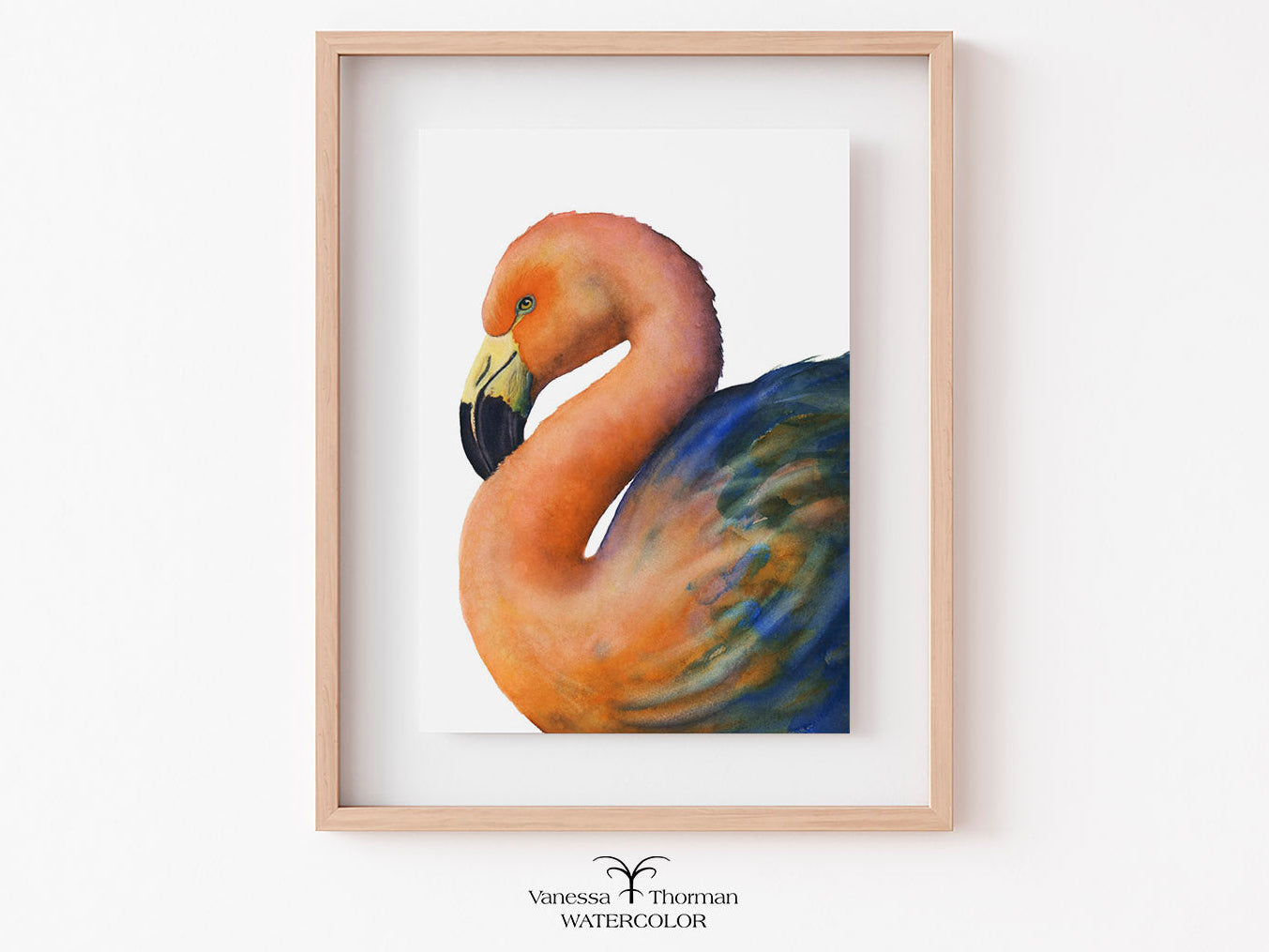 Framed watercolor painting of a flamingo on a white wall